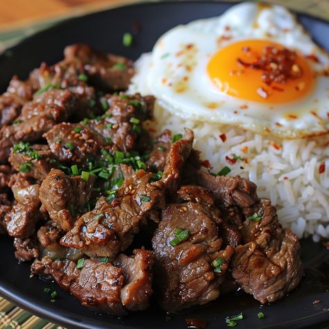 🍳 Enjoy the Filipino classic Tapsilog! 🍚✨ #Tapsilog #FilipinoFood Tapsilog (Marinated Beef, Garlic Rice, and Fried Egg) Ingredients: Beef sirloin, thinly sliced (1 lb) Soy sauce (1/4 cup) Vinegar (2 tbsp) Garlic, minced (4 cloves) Brown sugar (1 tbsp) Cooked rice (2 cups) Garlic, minced (2 cloves) Eggs (2) Vegetable oil (for frying) Salt and pepper (to taste) Instructions: Marinate beef in soy sauce, vinegar, garlic, and brown sugar for at least 30 minutes. Fry marinated beef in a skillet... Beef Aesthetic Food, Tapsilog Aesthetic, Cosy Meals, Pinoy Ulam, Tapsilog, Beef Tapa, Soy Sauce Rice, Garlic Rice, Filipino Cuisine