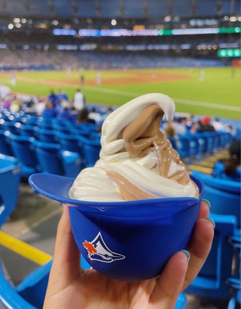 vanilla and chocolate soft serve swirl in blue jays baseball helmet cup, fun and affordable summer activities with friends Summer Activities With Friends, Chocolate Soft Serve, Activities With Friends, Blue Jays Baseball, Baseball Helmet, Baseball Game, Baseball Games, Soft Serve, Blue Jays