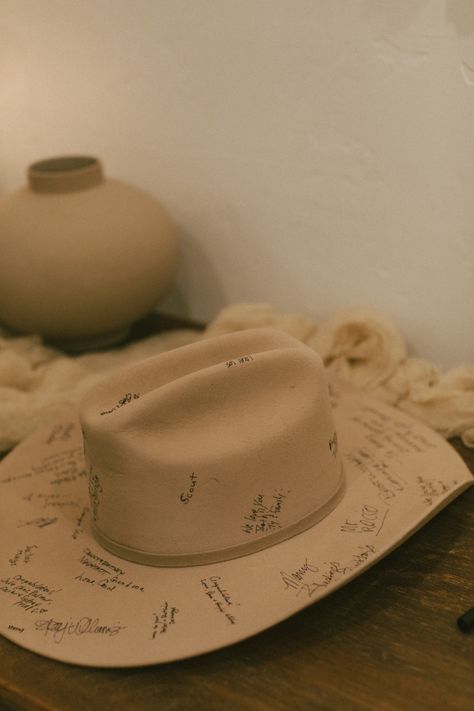 wedding guest book cowboy hat Cowboy Hat Guest Book Sign, Cowboy And Cowgirl Wedding Ideas, Cowboy Hat Wedding Guest Book, Cowboy Hat Signing Wedding, Country Cowboy Wedding, Halo Themed Wedding, Western Table Setting Wedding, Wedding Inspiration Western, Western Romance Wedding