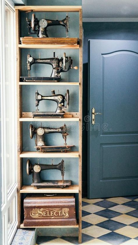 Photo about Krakow, Poland. September 22 2018. Vintage sewing machines on the wooden shelves in the retro room. Image of machines, three, shelf - 142451196 Sewing Machine Shelf, Vintage Sewing Display, Vintage Sewing Machine Display, Sewing Room Vintage Style, Dark Sewing Room, Antique Sewing Machines Decoration, Sewing Room Vintage, Vintage Sewing Tools, Vintage Sewing Room Decor