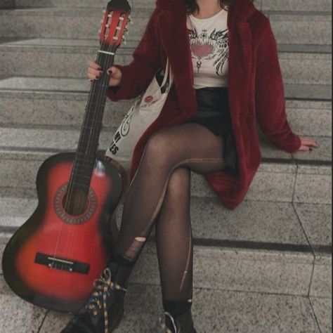 Girl sitting on stairs while holding a red guitar. She's waring a red fur coat with a black leather skirt and ripped tights. Body And Style Style Roots, Rockstar Outfits Aesthetic, 90s Pop Punk Aesthetic, Red Fits Aesthetic, Grunge Rockstar Aesthetic, Arabella Aesthetic, Rock Aesthetic Outfits, Rockstar Aesthetic Outfits, Rock Star Outfit