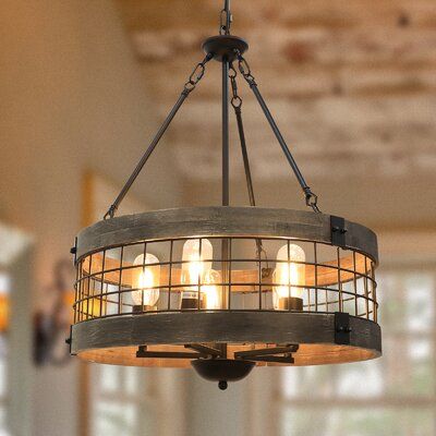 This industrial chandelier is designed with natural wood textures and black iron fence finishes, every detail carries the spirit of craftsmanship and is a unique artwork. Everyone who enters your home will praise it. Compatible flat, sloped and arched ceiling, is ideal for entryway, dining room, living room, kitchen island, bars, corridors, balconies, breakfast area ,foyer etc. | 17 Stories Farmhouse Rustic Chandelier 5-Light Round Hanging Pendant Light Fixture | Wayfair Island Bars, Dining Lights, Tattoo Foot, Wood Light Fixture, Farmhouse Lamps, Rustic Light, Rustic Pendant Lighting, Black Light Fixture, Hanging Pendant Light