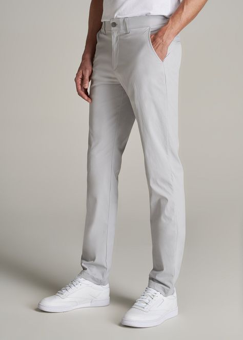 About Our Men's Tall Pants These extra-long chinos strike the perfect balance between classic and comfortable. They're designed to look like a pair of tapered chinos but are made of a lighter stretchy fabric that provides plenty of room for movement so you can tee off on the golf course, take the dog for a walk or grab dinner with friends at that new restaurant in town. We know how hard it is to find men's tall pants, which is why we made sure this pair had an extra-long inseam measured specific High Water Dress Pants Men, Light Gray Pants Outfit Men, Grey Pants Outfit, Grey Pants Men, Men Ootd, Tapered Chinos, Mens Slacks, Grey Chinos, Pants Outfit Men