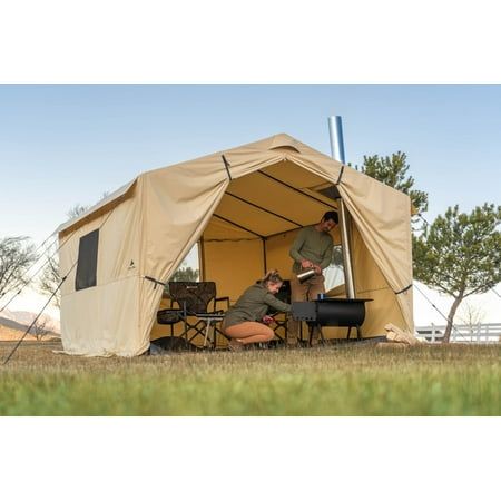 Get this Ozark Trail North Fork 12' x 10' Wall Tent for your outside exploring needs. It is convenient whether there's rain, sleet or snow. The canvas-imitation fabric on this wall tent with a stove jack wraps around a frame with adjustable legs and eaves to place it on uneven ground. Setup is easy with the color-coded poles and hubs, while a removable PVC floor keeps you dry from underneath. Fit your heat source in the outdoor tent, with its integrated section that fits pipes up to 5" in diamet Hot Tent Camping, 12 Person Tent, Campsite Setup, Tent With Stove, Canvas Wall Tent, Window Storage, Survival Tent, Hot Tent, Tent Living