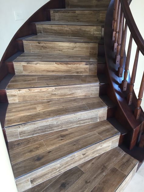 Wood looking tile with newly stained banister Wood Tile On Stairs, Tiles For Stairs Ideas, Stair Tiles Ideas, Stained Banister, Wood Tile Stairs, Stairs Wood, Faux Wood Tiles, Tiled Staircase, Laminate Stairs