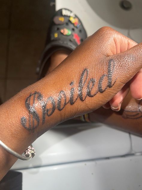 spoiled girl tattoo 
tattoos for girls Spoiled Tattoo Ideas, Female Hand Tattoos Ideas, Spoiled Tattoo, Thug Tattoos For Women, Boujee Tattoos For Women, Tattoo Ideas Female Wrist, Princess Tattoo Ideas, Money Tattoo Designs, Money Sign Tattoo