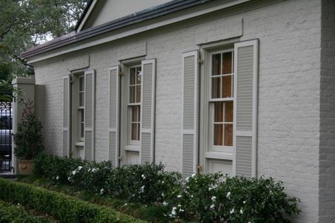 light grey painted brick with dark roof. I'd switch out to dark shutters and some white contrast elsewhere. Exterior Home Paint Colors, Exterior Brick House Colors, Ranch Exterior Makeover, Grey Shutters, Grey Painted Brick, Painted Brick Ranch, Grey Brick Houses, Thatch House, Brick House Colors