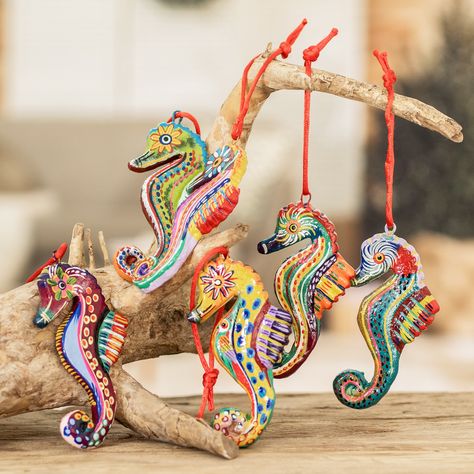 "When I was a little boy I loved everything that had to do with the sea and its creatures, especially seahorses. They are so morphologically different to the rest of the fish that I was fascinated by them. This childhood interest now inspires me to design these ornaments," confides José Arriola. The Guatemalan artisan handcrafts the ornaments of ceramic and paints each one with acrylics with different themes. The six ornaments hangs from bright red ribbons, and the set arrives in a traditional cotton pouch woven on a pedal-loom. Tiki Kitchen, Upcycled Handbag, Seahorse Ornament, Clam Shells, Ear Cuff Jewelry, Funny Earrings, Fish Ornaments, Art Sea, Ceramic Techniques