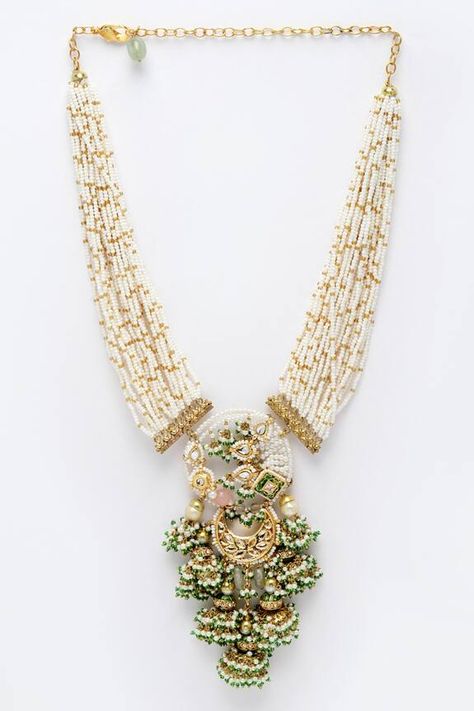 Gold plated necklace with multi layered pearl strand, kundans, American diamonds and natural stones. Type: Kundan, American Diamond, Pearls, Natural Stones Composition: Sterling Silver Color: Green, Pink, Gold, White Multi layered string Embellished pendant drop Size (in cms): L x W: 45 x 6 Weight (in gms): 116 Closure: Lobster clasp - Aza Fashions Gold Diamond Bangles Design, Pearl Necklace Designs Indian, Pearls Jewelry Indian, Pearl Jewelry Necklace Indian, White Beads Necklace, Moti Necklace, Bride Pearl Necklace, Pearl Mala, Real Diamond Necklace