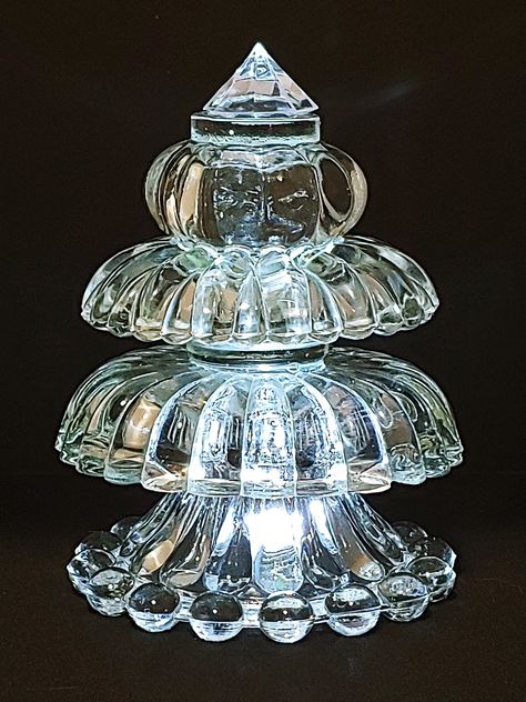 "This one-of-a-kind elegant Christmas tree is made using upcycled glass and crystal rescued from thrift stores and garage sales.  I hope your Classical Glass Christmas tree will become a part of your holiday mantel decoration or perhaps be part of a holiday dinner center piece. This tree is approximately 7\" tall, 5\" wide and is lit from below using the included multi-colored t-light which rotates from red to green to blue to purple.  An optional clear white t-light is available. The t-light is Diy Crystal Christmas Tree, Glass Bowl Christmas Tree, Crystal Tree Diy, Christmas Tree Dyi, Glassware Garden Art, Glassware Crafts, Holiday Mantel, Crystal Christmas Tree, Elegant Christmas Trees