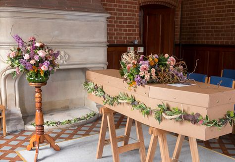 Cardboard coffin dressed with garland, hand-tied bouquet and a vase arrangement Coffin Flowers, Cardboard Coffin, Casket Flowers, Twine And Twig, Hand Tied Bouquet, Sympathy Flowers, Vase Arrangements, Floral Foam, Chrysanthemum