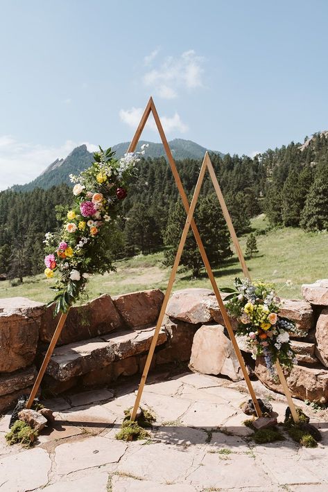 Mountain Wedding Ceremony Arch | Halfway House Wedding in Boulder, CO | A breathtaking wedding arch set against a stunning Colorado mountain wedding backdrop. The geometric wooden structure is adorned with vibrant colorful wedding floral arrangements. Book Nina for your Colorado wedding or adventure elopement at larsenphoto.co! Mountain Wedding Ceremony, Ceremony Arches, Wedding Floral Arrangements, Halfway House, Colorado Mountain Wedding, Wedding Ceremony Arch, Mountain Wedding Colorado, Wedding Ceremony Backdrop, Breathtaking Wedding