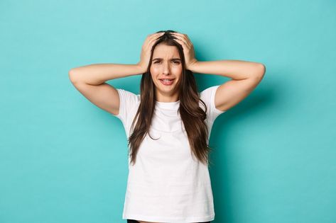 Image of woman in panic, looking at camera and holding hands on head, standing distressed and alarmed over blue background. Hands On Head, Fall Blonde Hair Color, Hand On Head, Fall Blonde Hair, Fall Blonde, Woman Standing, Female Images, Blonde Hair Color, Blue Background