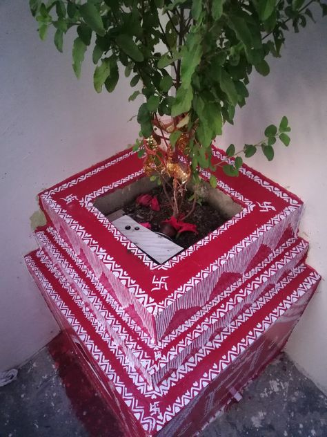 Maa tulsi mandir is decorated with red and white paint, traditionally geru and rice paste was used. Tulsi Vivah Painting, Tulsi Painting, Tulsi Pot Design, Pahadi Culture, Tulsi Puja, Tulsi Pot, Tulsi Vivah, Tulsi Plant, Rangoli Designs Simple Diwali