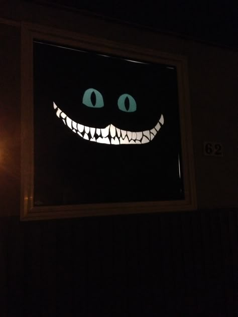 Cheshire Cat in front window. Alice in Wonderland Halloween decoration for house. Alice In Wonderland Stills, Alice In Wonderland Haunted House Ideas, Cheshire Cat Decor, Alice In Wonderland Party Entrance, Alice In Wonderland Set Design Theatres, Cheshire Cat Decorations, Alice In Wonderland Halloween Theme, Alice In Wonderland Window Display, Alice In Wonderland Haunted House