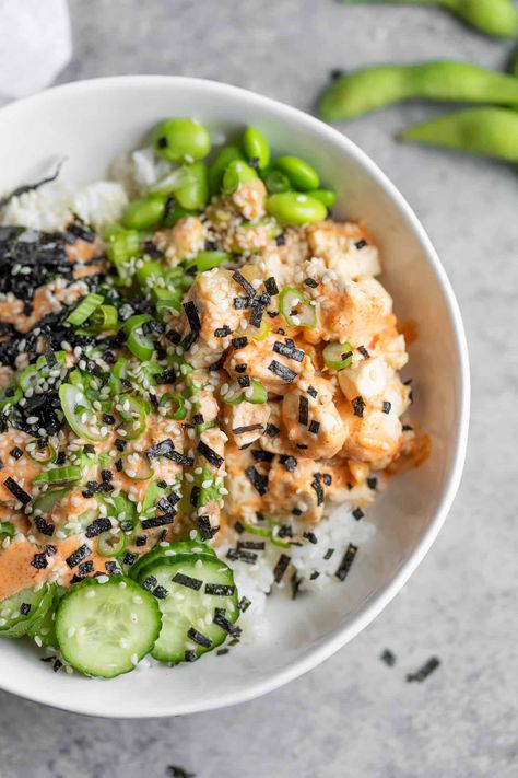 If you love poke, then you'll love this tofu poke bowl! With crispy chili tofu, sushi rice, quick pickled cucumbers, nori, avocado, and a spicy mayo sauce. Naturally vegan and gluten-free. Spicy Tofu Bowl, Cucumber Poke Bowl, Tofu Poke Bowl Recipe, Veggie Sushi Bowl, Tofu Sushi Bowl, Vegetarian Poke Bowl, Vegetarian Sushi Bowl, Crispy Tofu Bowl, Tofu Poke Bowl