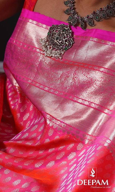 Striking Neon Pink hue adds glorious enamour to this Kanjivaram Silk Saree with silver zari layered diamond brocade. The chic weave is accentuated with a self silver zari border with Intricately crafted florals, rudraksh, peacocks, brocade and baby pink selvage. The opulent self zari brocade pallu, and the plain pink blouse are a fabulous compliment.    Jewellery - @thetiysha   Shop for similar sarees at - www.deepam.com . . . #Kanchipuramsilk #Kanchisilksaree #Kanchipuramsaree #Sixyardsofelegan Silver Zari Pattu Sarees, Silver Zari Saree, Pattu Sarees Wedding, Silk Saree With Silver Zari, Zari Saree, Saree Jewellery, Sarees Wedding, Kanjivaram Silk Saree, Saree Trends