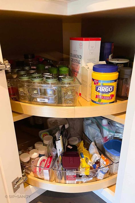 Organize your spices in a lazy susan cabinet for easy access, efficiency, and to make the most of your dried herbs and spices. Check out the steps, considerations and space saving methods to create your own well organized storage space. Spice Cabinet Lazy Susan, Spin Cabinet Organization, Dry Herb Storage Ideas, Kitchen Turntable Cabinet Organization, Spice Organization Lazy Susan Corner Cabinets, Spice Organization Corner Cabinet, Spice Organization Lazy Susan, Corner Cabinet Lazy Susan Ideas, What To Put In A Lazy Susan Cabinet