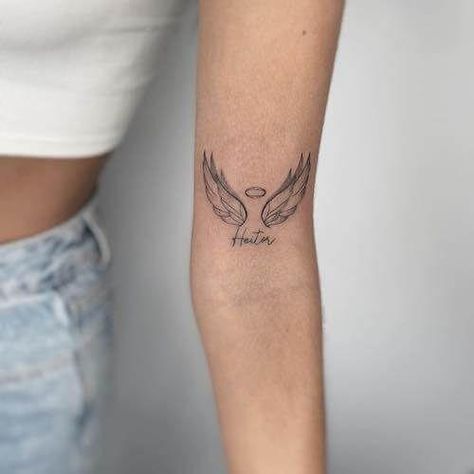 Angel Wings And Roman Numeral Tattoo, Youll Be In My Heart Always Tattoo, 222 With Angel Wings Tattoo, Memorial Angel Tattoo, Angle Wings Tattoo For Women, Letter With Angel Wings Tattoo, Cross And Angel Wings Tattoo, Feminine Angel Wings Tattoo, Tattoo With Angels