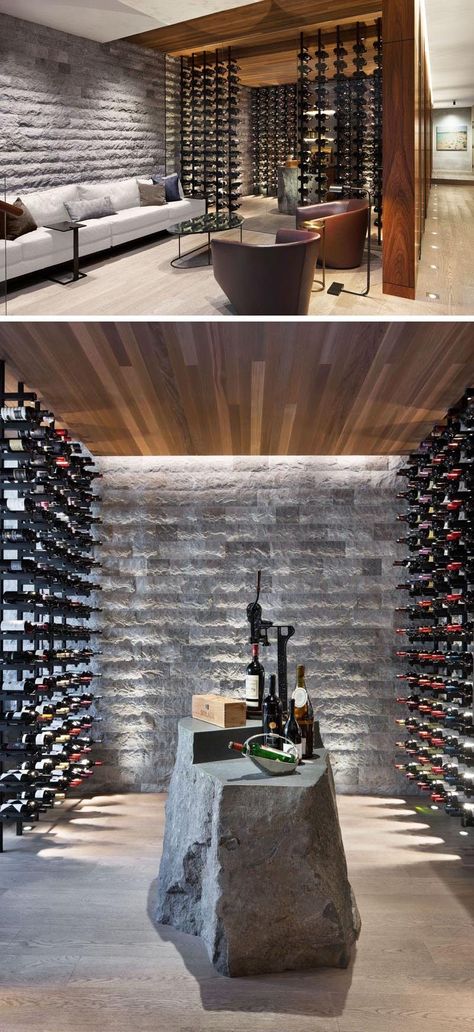 This modern wine cellar has glass walls, plenty of bottle storage, and a stone element that's been designed to be used as a table. #WineCellar #WineRoom #WineStorage Wine Degustation Design, Wine Cellar Modern, Modern Wine Cellar, Underground Cellar, Canadian House, Wine Cellar Basement, Estate Gardens, Grey Accent Wall, Wine Cave