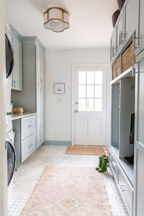 Picture of a light blue mudroom laundry with shaker cabinets, an open storage unit, baskets and printed rugs, a washing machine and a dryer Easy To Clean Home Design, Laundry Flooring Ideas, Mudroom Tile, Laundry Mudroom Combo, Mud Room Laundry Room Combo, Laundry Room/mud Room, Sunroom Addition, Diy Mudroom, House Addition