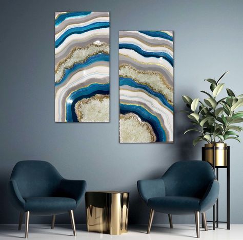 "An original, handmade, blue and gold resin geode wall art, perfect as luxury wall decor and unique gifts. A beautiful epoxy resin art piece for modern style home that create a unique decor for any room. Stunning one of a kind geode painting in ocean blue, grey and gold undertone. The Epoxy Resin painting measures 30X30\"( two piece) and is handmade on gallery style wooden panel of depth 1.5 inches. Made with high quality pigments, glitters, glass crystals and real quartz Crystal embedded in mul Resin Geode Wall Art, Geode Resin Art, Luxury Wall Decor, Geode Painting, Geode Wall Art, Diptych Art, Geode Wall, Resin Geode, Resin Art Painting