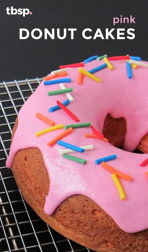 Two bright pink, glazed and donut-shaped strawberry cakes topped with sprinkles. For a show-stopping treat everyone will love, this recipe is a must-make! Donut Shaped Cake, Donut Cakes, 9th Birthday Cake, Glaze For Cake, Diy Donuts, Pink Donut, Holiday Tips, Pink Food Coloring, Birthday Breakfast