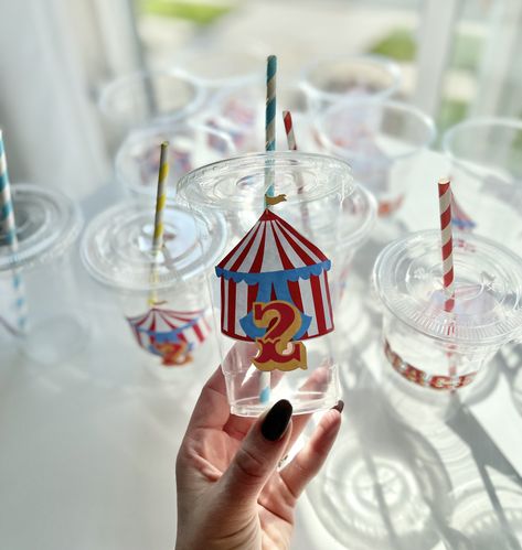 "My current processing time is 2-3 weeks. (not including shipping) Custom Carnival/Circus Theme Party Favor Cups Matching Cake Toppers, Cupcake Toppers, Favor Boxes, Centerpieces & 3D letters also available. Matching Banner: https://www.etsy.com/listing/1286706371/circus-carnival-theme-banner?click_key=7af9e57738a22125e0dc89af803d337509f6b044%3A1286706371&click_sum=472af8a2&ref=shop_home_active_1 Matching Centerpieces:  Matching Popcorn Cart Favor Boxes: https://www.etsy.com/listing/1272706178/popcorn-cart-party-favor-boxes?ref=listings_manager_grid NAME OPTION NO LONGER AVAILABLE! **OVERVIEW**   - These are plastic disposable party cups   - Blue, yellow, and red paper straws will come with it.   - These cups are meant for one time use.   - Cups will come not put together, you will need to Carnival Circus Theme Party, Popcorn Cart, Party Favor Cups, Carnival Birthday Party Theme, Circus Carnival Party, Carnival Circus, Circus Theme Party, Favor Cups, Kid Parties