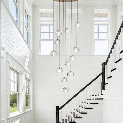 A beautiful crystal chandelier spiraling downward will add elegance and ambiance to any dining room, entry, or foyer a masterfully designed, sparkling work of art. Base Finish: Brass | Ivy Bronx Bigham 12 - Light Cluster Chandelier LED Long High Ceiling Pendant for Stairs Crystal in Yellow | Wayfair 2 Story Foyer Lighting, Stairway Chandelier, Entry Chandelier, Dining Room Entry, Entryway Chandelier, Foyer Lighting Fixtures, Cluster Chandelier, Entry Lighting, Chandelier Led