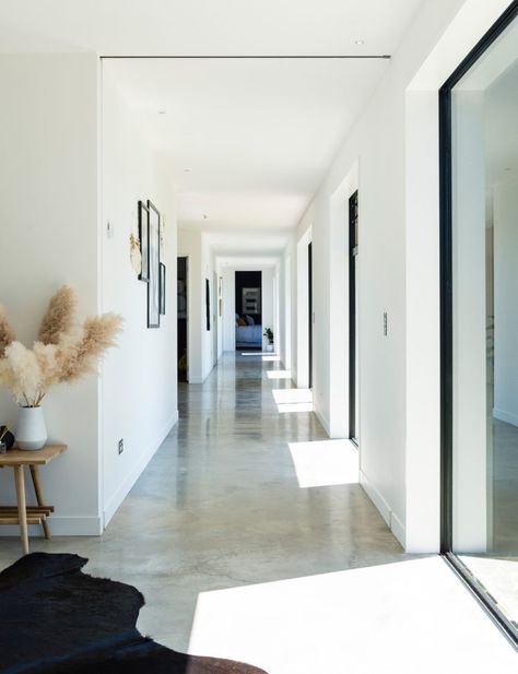 How concrete, metal and timber is warm and welcoming in this chic home Styling Concrete Floors, Concrete Floors Modern Home, Polished Concrete Floor Interior Design, White Concrete Flooring, Cozy Concrete Floors, Brushed Concrete Floor, Light Colored Concrete Floors, Raw Concrete Floors, Glossy Concrete Floors