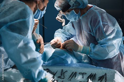 Stock Image: In the hospital operating room. An international team of professional surgeons and assistants works in a modern operating room. Professional doctors celebrate successfully saved lives. Hospital Operating Room, Operating Room, In The Hospital, Creative Icon, The Hospital, It Works, Stock Images, Stock Photos, Celebrities