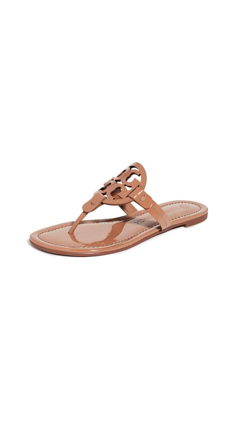 PRICES MAY VARY. Rubber sole Logo cutout Flat profile Open toe An update to one of the label's signature styles, these Tory Burch sandals are crafted from glossy patent leather and feature a prominent logo cutout for an elevated addition to all your casual summer ensembles. Embellished Sandals, Tory Burch Sandals Outfit, Tory Burch Miller, Tory Burch Flip Flops, Tory Burch Miller Sandal, Signature Styles, Tory Burch Sandals, Sandals Outfit, Girly Shoes