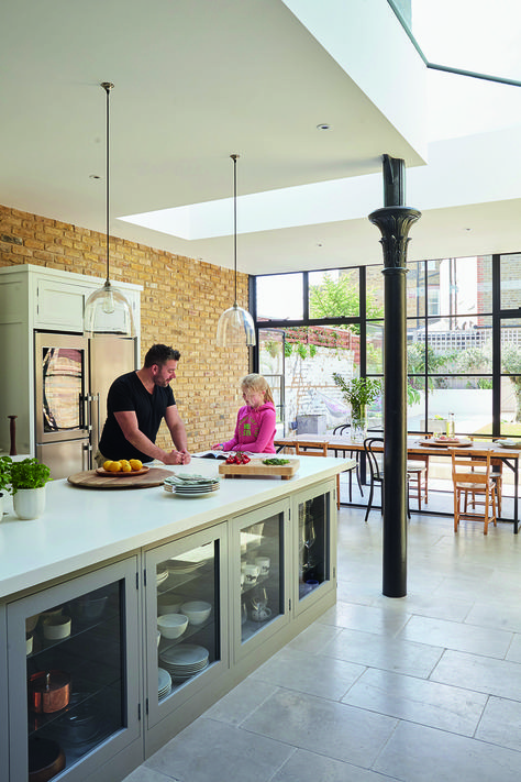 Wandsworth Common Westside - Granit Eclectic style extension to existing property in Wandsworth, South West London with steel framed windows. Handless Shaker style kitchen with glass pendant lights above. Dining table with mis-matched chairs. Mix of styles. Reclaimed structural column - taken from an old bandstand! Main Units in: Little Greene ‘French Grey Pale’ Island in: Little Greene ‘Lead Colour’ Lighting Kitchen Island, Framed Windows, Track Lighting Kitchen, Kitchen Diner Extension, Open Plan Kitchen Dining, Open Plan Kitchen Living Room, Kitchen Island Table, Shaker Style Kitchens, House Extension Design