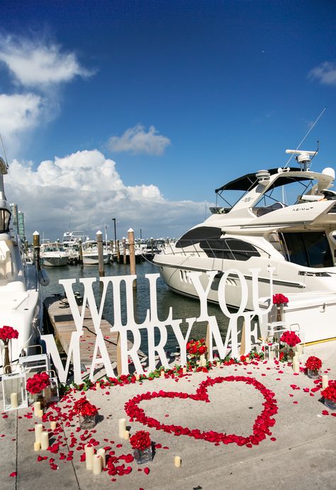 This Will You Marry Me setup is the best proposal idea if you want to pop the question at marina or near the yacht! Rose petals, candles and a big sign make the strong statement! #yachtproposal #proposalideas #willyoumarryme Yacht Proposal Ideas, Boat Proposal Decoration, Miami Proposal Ideas, Will You Marry Me Beach, Proposal Yacht, Will You Marry Me Ideas, Downtown Proposal, Will You Marry Me Ideas Proposals, Proposal Setups