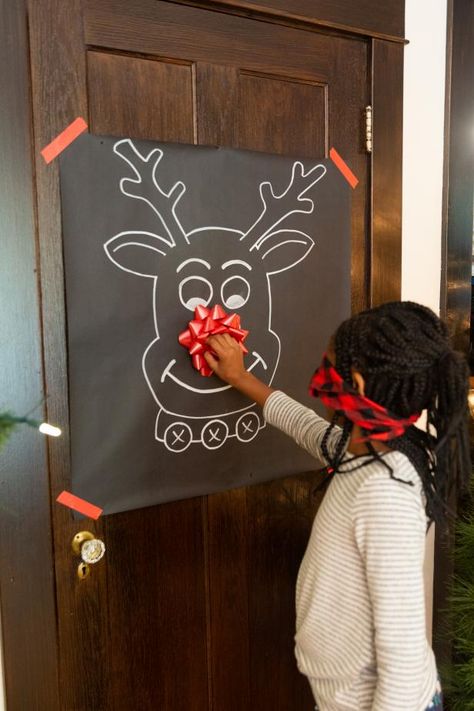 Put your art skills to the test with this Christmas twist on a classic party game. To craft your pin-the-nose-on-Rudolph game, all that's needed is a paint marker, black craft paper and a gift bow. To play, tape the reindeer face to a door and take turns wearing a blindfold while trying to pin the Christmas bow to Rudolph's nose. Christmas Game Ideas, Preschool Christmas Party, Xmas Party Games, Christmas Eve Games, Fun Christmas Party Ideas, Fun Family Christmas Games, Christmas Party Activities, School Christmas Party, Diy Christmas Party