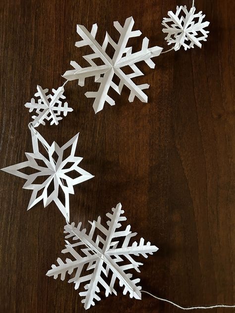 How to Make Paper Snowflake Garland for Christmas; Hanging Paper Snowflakes From Ceiling, Window Snowflakes Diy, Snowflake Paper Garland, Paper Snowflake Garland Diy, Paper Christmas Garland Diy, Snowflake Garland Diy, Paper Snowflakes Pattern, Paper Snowflake Garland, Window Snowflakes