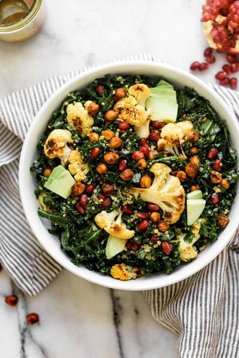 a nourishing & filling winter salad, this winter glow bowl is loaded with the best feel-good winter ingredients: roasted cauliflower, pomegranate arils, avocado, & kale, which all get tossed together in a homemade curry vinaigrette with spiced roasted chickpeas. winter salads have never looked this good! #salad #mealprep #saladrecipe #kalesalad #curryvinaigrette #roastedcauliflower #roastedchickpeas #playswellwithbutter Roasted Cauliflower Curry, Cauliflower Pomegranate, Glow Bowl, Chickpeas Roasted, Winter Salads, Homemade Curry, Spiced Chickpeas, Cauliflower Curry, Winter Salad