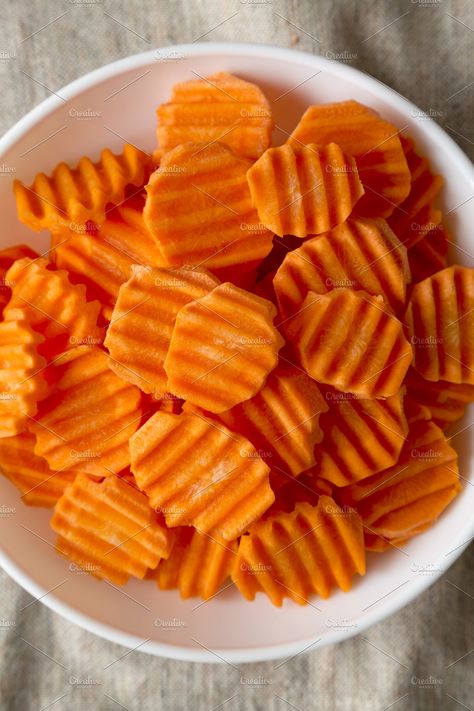 Fresh Raw Organic Carrot Chips in a white bowl on cloth, top vie Carrot Chips, Snack Boxes, Raw Carrots, Work Lunches, View From Above, White Bowl, Carrot Recipes, Work Lunch, Snack Box