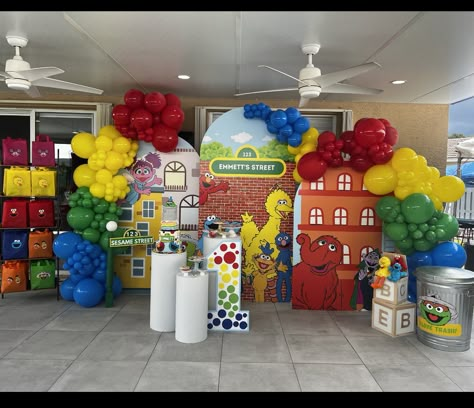 Sesame Street birthday backdrop. Foam walls, balloon garlands, cylinders for desserts and aesthetics. Affiliate link for affordable cake stand cylinders. #sesamestreetparty #sesamestreet #elmobirthdayparty #elmo #birthdaydecoration #sesamestreetcenterpiece #1stbirthday #cylindercakestand #cakestand #cakes #backdrop Elmo Balloon Garland, Sesame Street Balloon Arch, Elmo Backdrop, Diy Sesame Street Decorations, Sesame Street Birthday Party Ideas 1st, Sesame Street Party Decorations, Sesame Street Backdrop, Pedestal Decor, Elmo Party Decorations