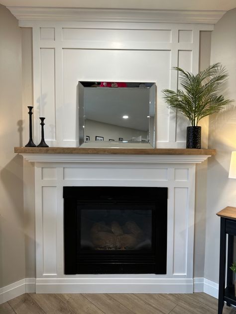 White shaker fireplace with natural wood stained mantle White Mantle With Wood Top, Shaker Fireplace Mantel, Shaker Style Fireplace Surround, White Trim Fireplace, White Wood Mantle Fireplace, White Fireplace Surround Wood Mantle, Wood Mantle Slipcover, Wood Mantle Surround, Natural Wood Fireplace Mantle