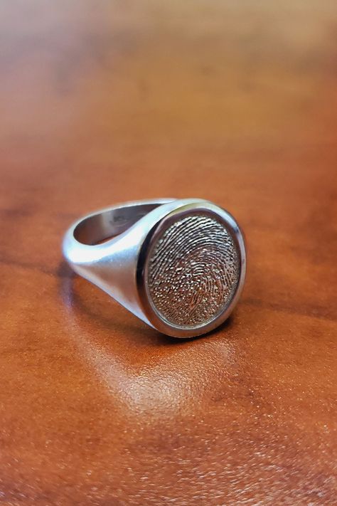 A sterling silver Thumbies fingerprint Signet Ring on a wooden desk Signet Rings, Signet Ring, Fingerprint, Ring Designs, Animal Print, Hand Made, Engagement Rings, Pet, Sterling Silver