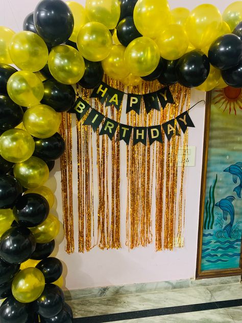 It is a Birthday decor with golden and black balloons on the left side and top with golden shimmer backdrop and black happy birthday hanging on it. Birthday Decorations At Home, Black And Gold Theme, Simple Birthday Decorations, Black Theme, Golden Birthday, Birthday Decor, 16th Birthday, My Birthday, Birthday Decorations