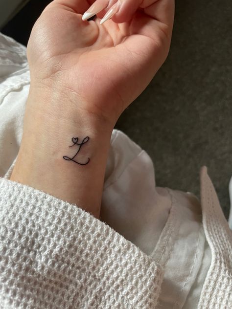 L initial tattoo with heart Tattoos For Initials, Partner Name Tattoo Ideas, Small L Tattoo Letter, Red Ink Initial Tattoo, Initial L Tattoo, L Tatoos Initial, Letter S Tattoo Ideas Initials, Mini Initial Tattoo, Small L Tattoo