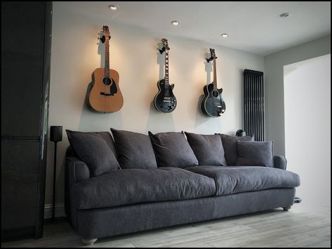 Wall hung guitar display feature wall.  Dimmable spot lights placed above each one to really highlight the guitars. Guitars Hanging On Wall, Guitar Feature Wall, Hanging Guitars, Guitar Display, Guitar Wall, Diy Balloon Decorations, Spot Lights, Bohemian Bedroom Decor, Work Spaces