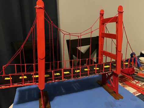 My daughters 4th grade project. We used popsicle sticks, hot glue gun, yarn, and red paint Popsicle Bridge, Stem Bridges, Popsicle Stick Bridges, Popsicle House, Science Exhibition Projects, Bridge Ideas, Bridge Project, Science Exhibition, Cardboard Creations