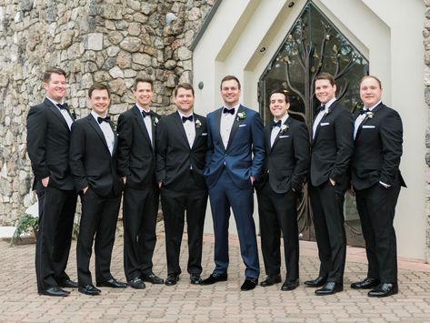 The groom designed his midnight navy tux, selecting everything from the fabric to the buttons. The wedding date was monogrammed on the back of his collar, and the couple’s crest was added to the lining. He added velvet shoes and fleur-de-lis socks in honor of his hometown of Louisville, Kentucky. The groomsmen wore their own traditional black tuxes. Midnight Blue Tuxedo Wedding, Navy Tuxedo Wedding, Groomsmen Attire Black, Groomsmen Attire Navy, Black Groomsmen Suits, Tuxedo Wedding Groomsmen, Blue Tuxedo Wedding, Navy Blue Groom, Navy Tux