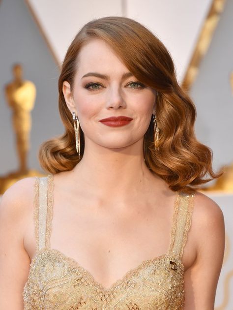 But if you take a closer look, Stone's Oscars 2017 look meant much more than just a lesson in red carpet slayage: Her ensemble carried an almost-hidden, political-slash-feminist statement, as well. On her left shoulder, right beneath the strap of her gown, Stone wore a gold Planned Parenthood pin. Bangs Sideswept, Bangs Updo, Oscar Hairstyles, Bombshell Hair, Oscars Red Carpet, Bangs For Round Face, Isabelle Huppert, Fringe Bangs, Bangs With Medium Hair