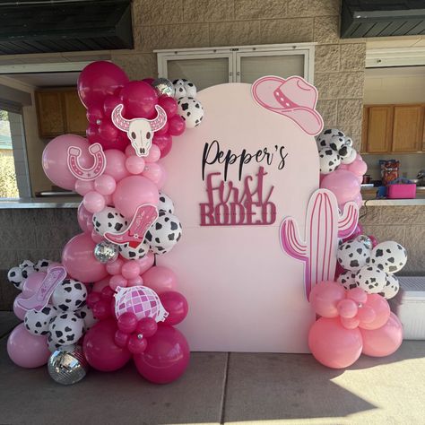 A pretty in pink disco themed first rodeo cowgirl birthday backdrop and balloon garlands with props. Cowgirl Birthday Party Backdrops, Rodeo Birthday Backdrop, Cowgirl Balloon Garland, 1st Rodeo, Rodeo Birthday Parties, Cowgirl Vibes, Pink Disco, Maternity Picture, Rodeo Birthday