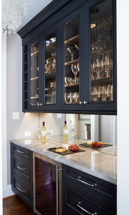 Dark blue butlers pantry features dark blue lower cabinets with polished nickel pulls flanking a stainless steel wine cooler fridge. Blue Butlers Pantry, Blue Lower Cabinets, Wine Cooler Fridge, Lower Cabinets, Home Wet Bar, Modern Home Bar, Dining Room Cabinet, Transitional Dining Room, Mirror Backsplash