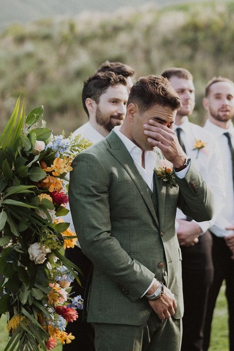 These two had the perfect spring-inspired wedding at Jumanji at Kualoa Ranch! The bride’s two-piece wedding dress was ethereal and romantic, the groom’s suit was the perfect spring sage green tone, and the florals were the perfect assortment of tropical and local flowers. Spring wedding inspiration, Spring wedding floral arrangements, spring mismatched pastel bridesmaids dresses, Hawaii tropical wedding, luxury Hawaii wedding photographer, romantic tropical luxury wedding ceremony inspiration White And Green Suit Men Wedding, Eucalyptus Wedding Groom, Groom Outfit Garden Wedding, Wedding Groom Green Suit, Garden Groomsmen Attire, Green Groom Wedding Party, Romantic Groom Attire, Groom Suits Green, Tropical Wedding Suit Men